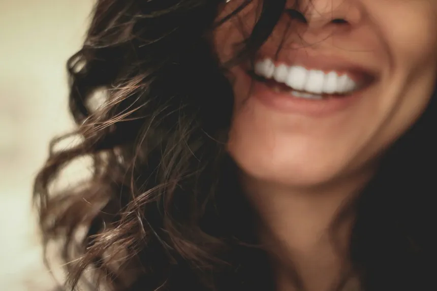 Woman smiling after cosmetic dental bonding treatment